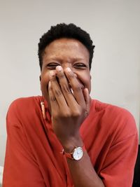 Portrait of teenage girl standing against white background