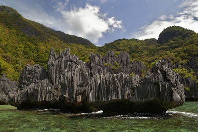 Scenic view of waterfall against sky