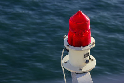 High angle view of red lighting equipment against sea