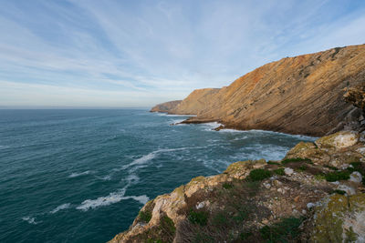 Sea cliffs landscape in cabo espichel at sunset, in portugal