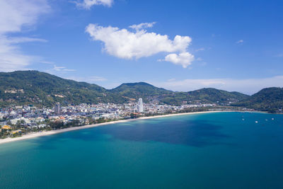 Scenic view of sea and city against sky