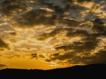 Silhouette landscape against scenic sky