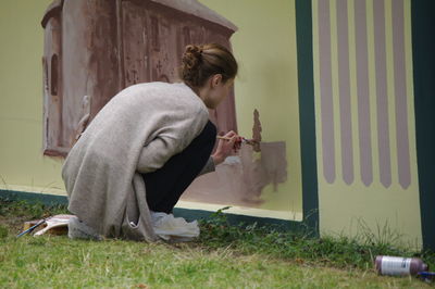 Side view of woman standing against plants