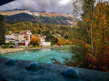 Scenic view of buildings and mountains against sky