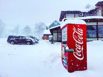 Information sign on snow against sky