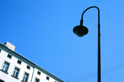 Low angle view of street light against clear blue sky