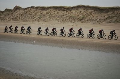 Side view of bicycling on country road