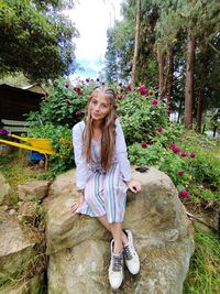 Young woman standing on rock