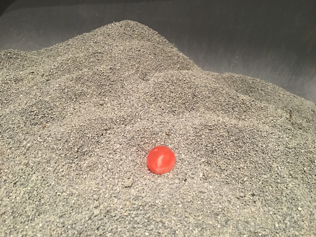 CLOSE-UP OF RED HEART SHAPE ON SAND