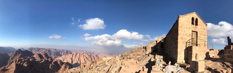 Panoramic view of castle against cloudy sky