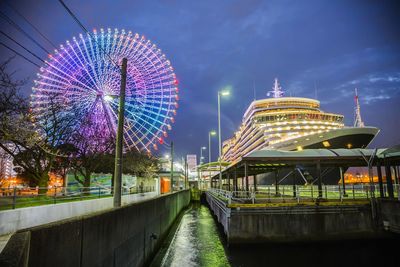 Illuminated ferris wheel at night