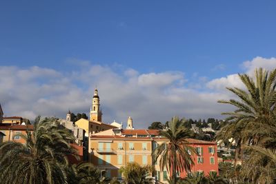 Buildings in town against sky