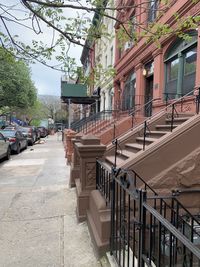Footpath amidst buildings in city