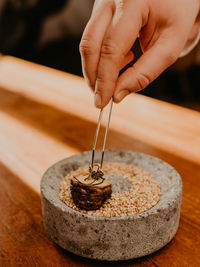 Cropped hand of person preparing food