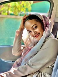 Portrait of smiling young woman in car