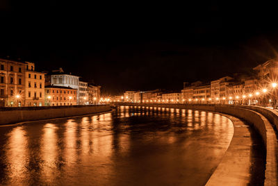 Canal passing through city at night