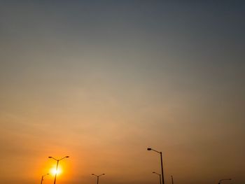 Low angle view of street light against sky during sunset