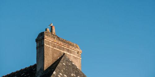 Low angle view of traditional building against clear blue sky