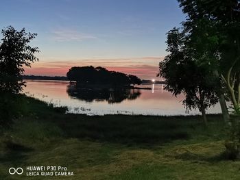 Scenic view of lake against sky during sunset