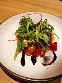 High angle view of fruits in plate on table