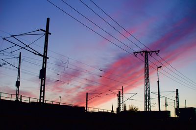 View of electricity pylons at dusk