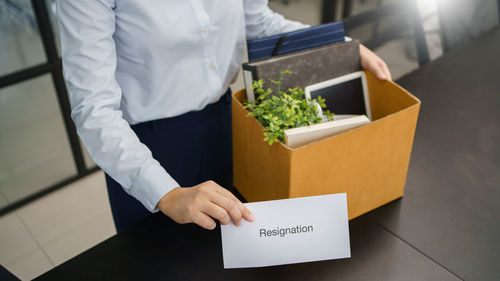 Midsection of man holding box