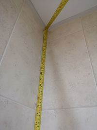 High angle view of yellow pattern on tiled floor