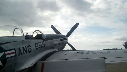 Airplane on runway against sky