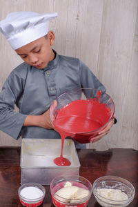 Boy preparing food on table at home