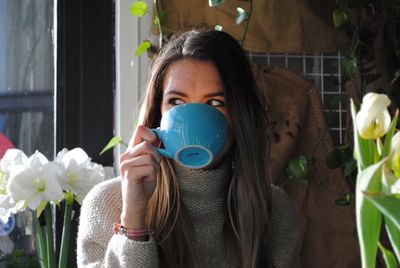 Woman drinking coffee in back yard