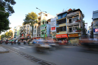 View of city street and buildings against sky