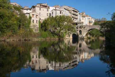 Ancient village of sauve reflected in the vidourle river