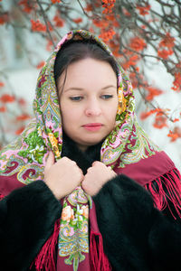 Close-up of beautiful woman standing against tree