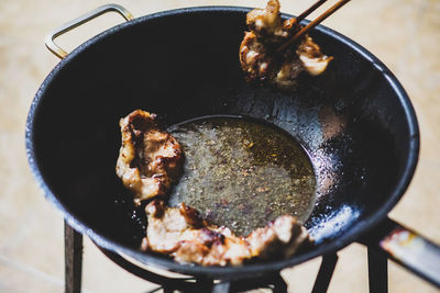 High angle view of meat in cooking pan