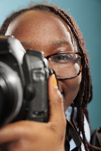 Close-up of man photographing with camera