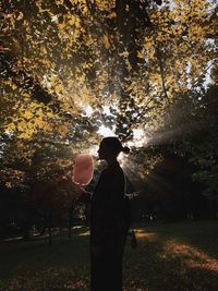Woman holding cotton candy in park