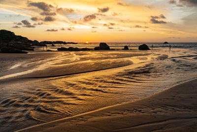 Scenic view of beach against sky during sunset