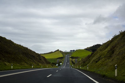 Road going through green hills