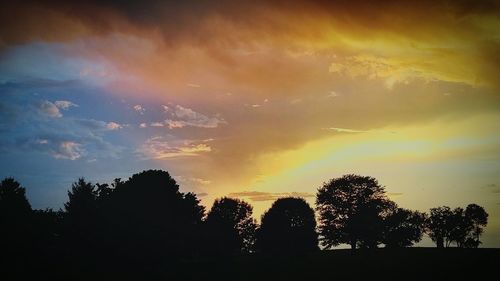 Silhouette trees against sky during sunset