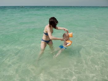 Mother and son playing in the sea