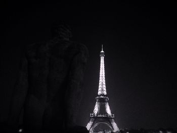 Low angle view of statue of tower at night