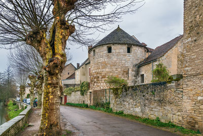 Footpath amidst buildings against sky