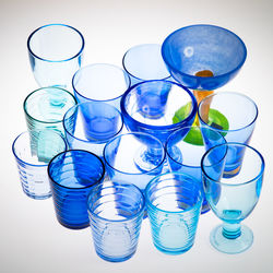 Close-up of empty glasses over white background