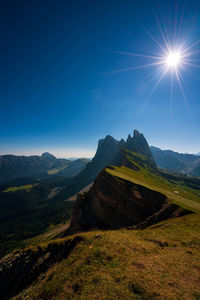 Scenic view of mountains against blue sky