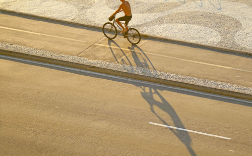 Low section of person riding bicycle