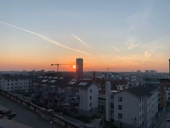 High angle view of buildings in city against sky during sunset