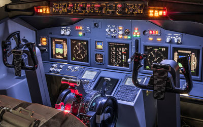 High angle view of illuminated control in airplane cockpit