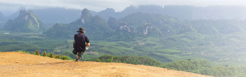 Solo traveller enjoying beautiful nature of hills. web banner size.