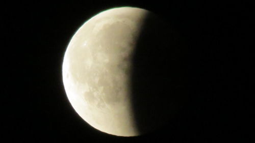 Low angle view of moon against sky at night