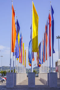 Low angle view of flags in row against sky